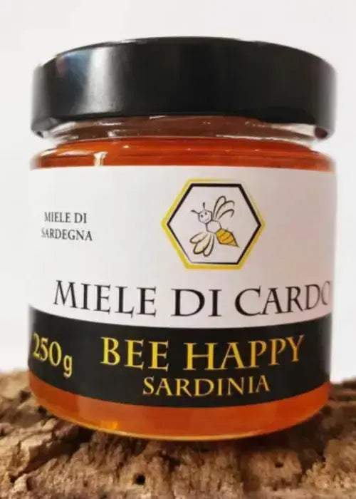 Barattolo di miele di cardo liquido ambrato chiaro con etichetta tipica