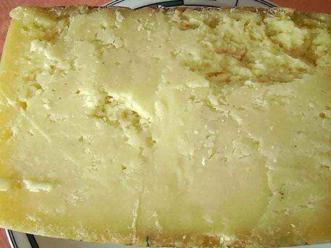 Pecorino sardo cheese assortment on wooden board with fresh and aged varieties from Sardinia Italy