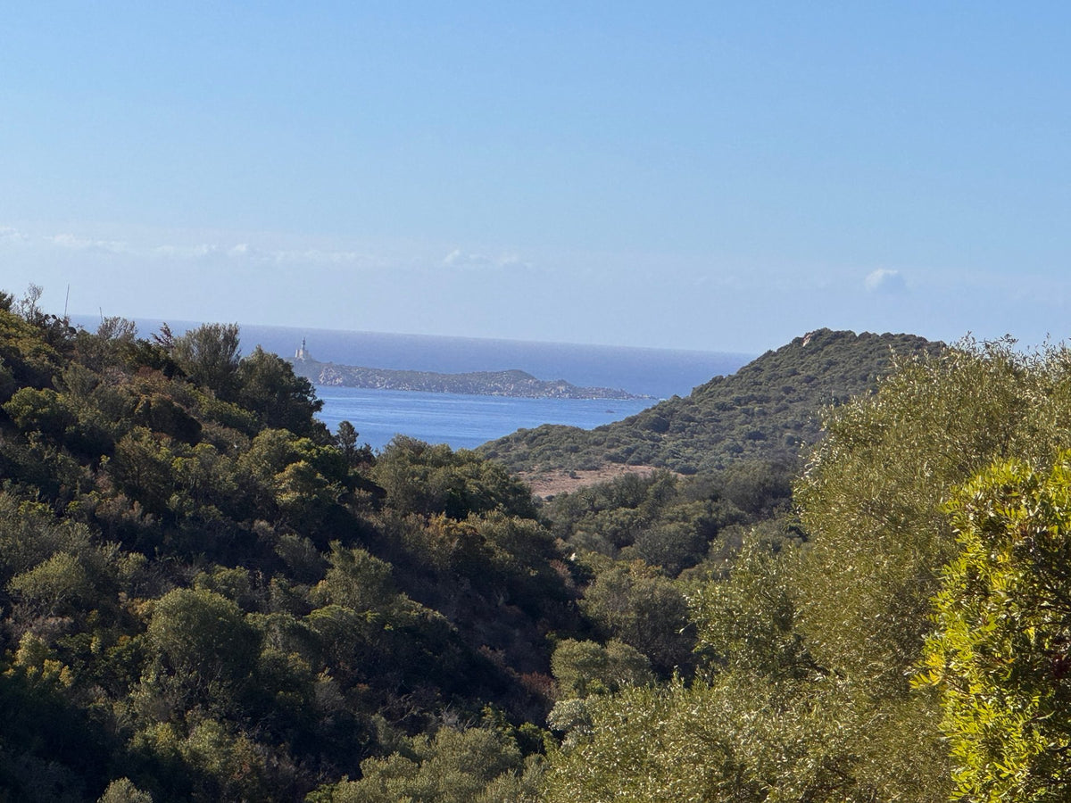 Le colline di macchia mediterranea sopra Villasimius, con il mare e il faro dell'Isola dei Cavoli sullo sfondo